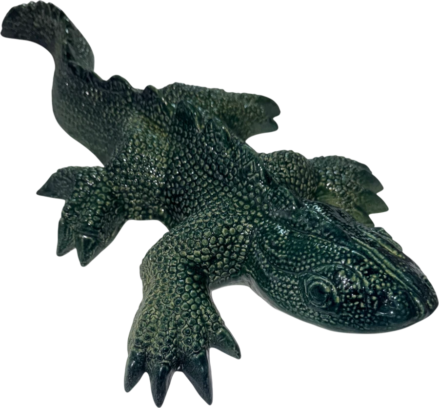 Large dark green ceramic gecko, finely scaled, with its head raised