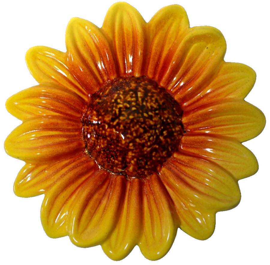 Large ceramic sunflower with yellow petals flushed orange and a dark brown seeded centre