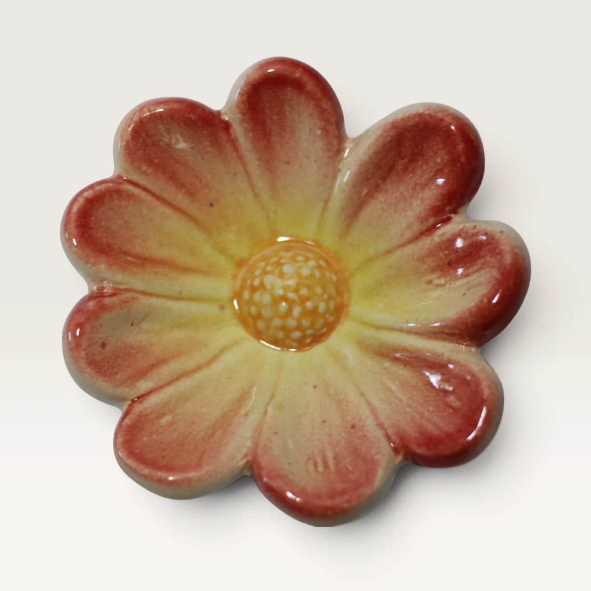 Round-petalled ceramic flower in cream-yellow flushed red at the tips, with a yellow centre