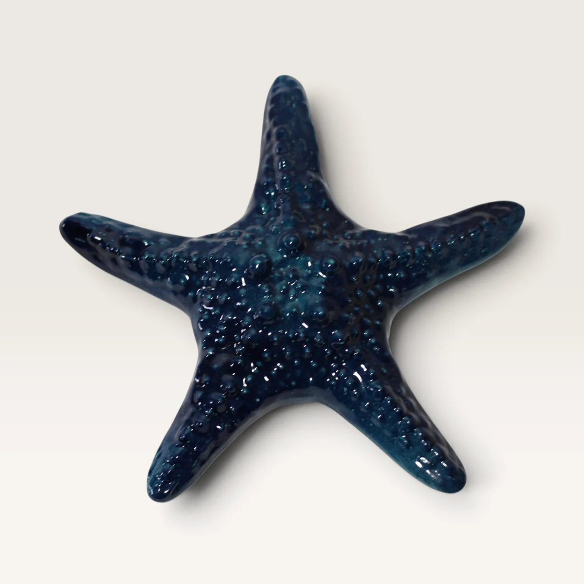 Dark blue ceramic starfish with a bumpy texture